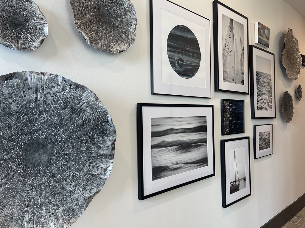 a wall of pictures and art on a white wall