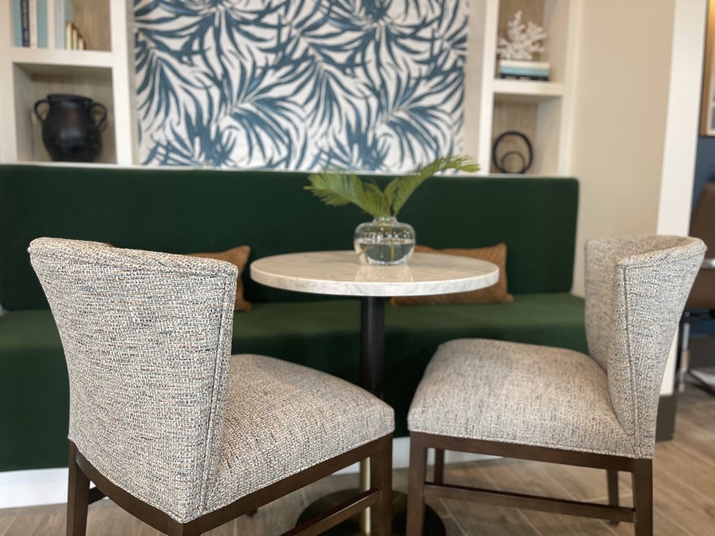 a living room with a table and two chairs