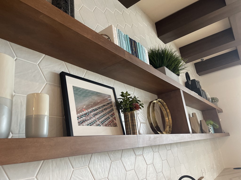 a shelf in a living room with a picture on it