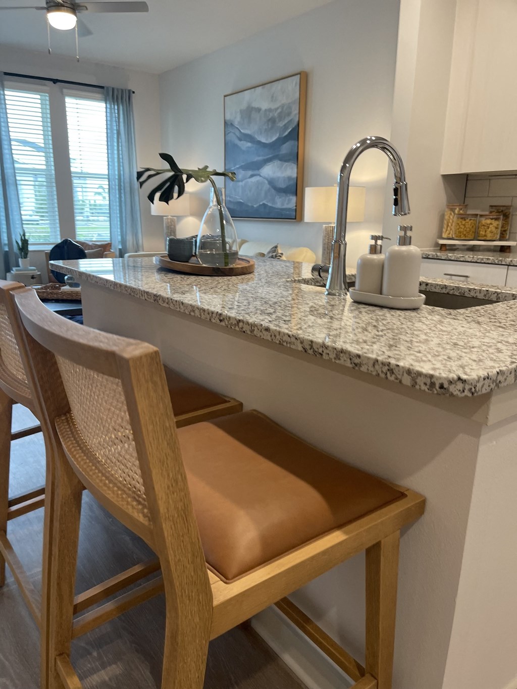 a kitchen with a marble counter top and two stools