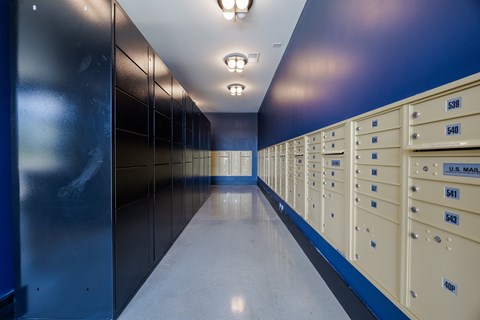 A long hallway of U.S. Mail mailboxes.