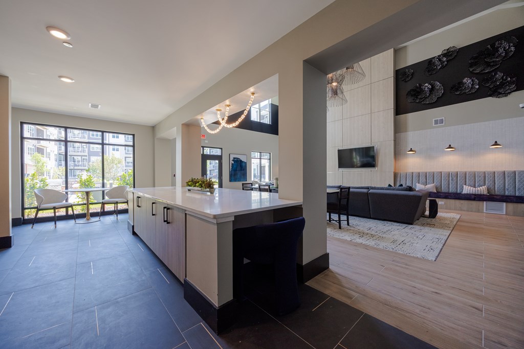 A modern kitchen with a large island and a dining area.