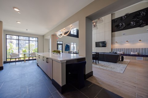 A modern kitchen with a large island and a dining area.