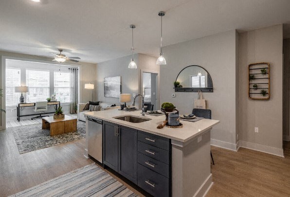 a kitchen with an island and a living room