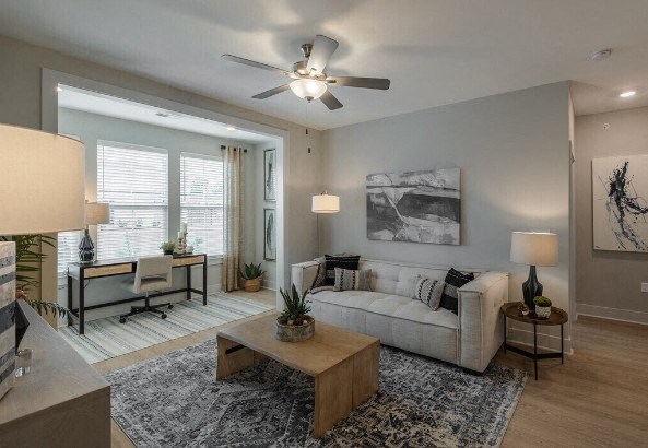 a living room with a couch and a ceiling fan