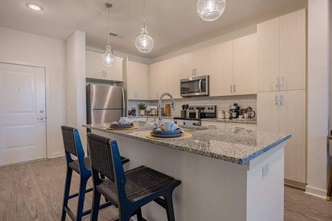 Upscale Kitchen with Island and Stainless Steel Appliances at Madison Fountains Apartments in St. Johns, Florida