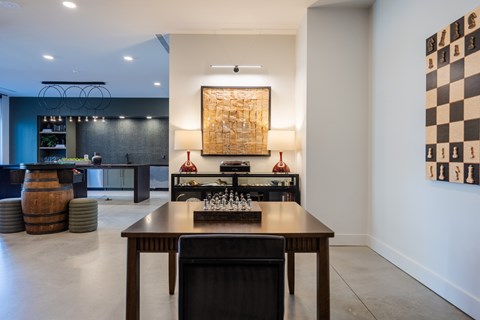 A modern dining room with a wooden table and chairs.