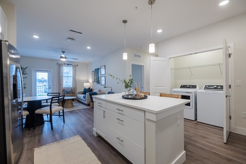 A modern kitchen with white cabinets and a large island.