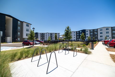 A playground with swings and a building in the background.