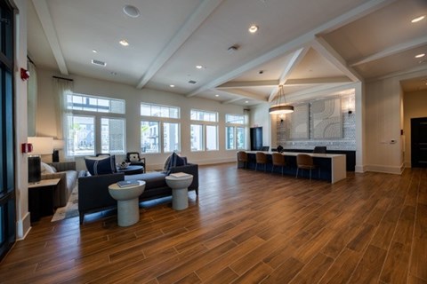 A spacious living room with wooden floors and a large window.