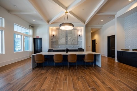 A modern dining room with a long table and chairs.