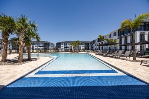 A long rectangular pool with a blue tiled edge and a white tiled edge.