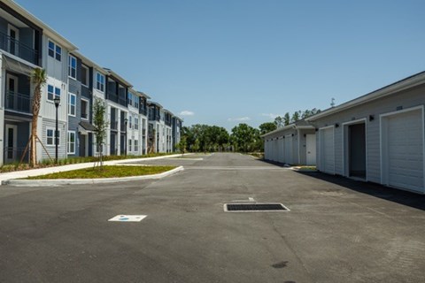 A parking lot in front of a row of houses.