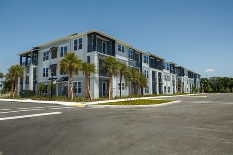 A large building with a parking lot in front of it.