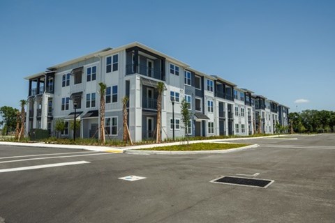 A large building with a parking lot in front of it.