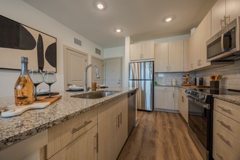 A kitchen with wooden cabinets and stainless steel appliances.