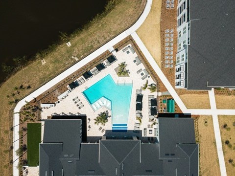 An aerial view of a swimming pool surrounded by buildings.