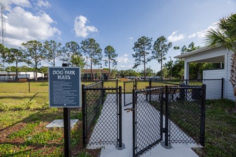 A sign in a dog park lists the rules.