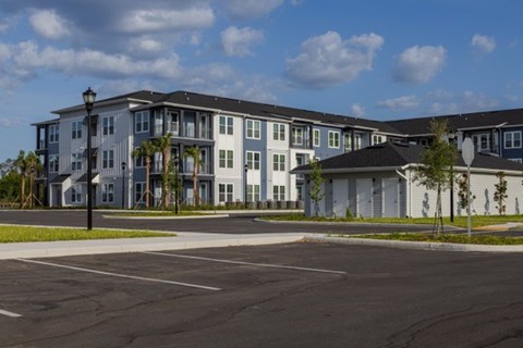 A large building with a parking lot in front of it.