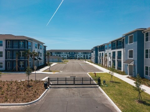 A gated entrance leads to a row of modern townhouses.