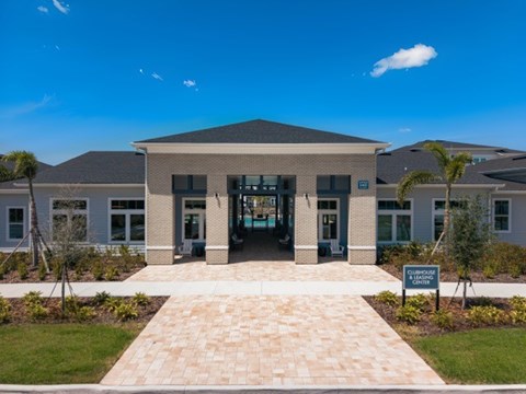 A building with a sign that says "Clubhouse" in front of it.