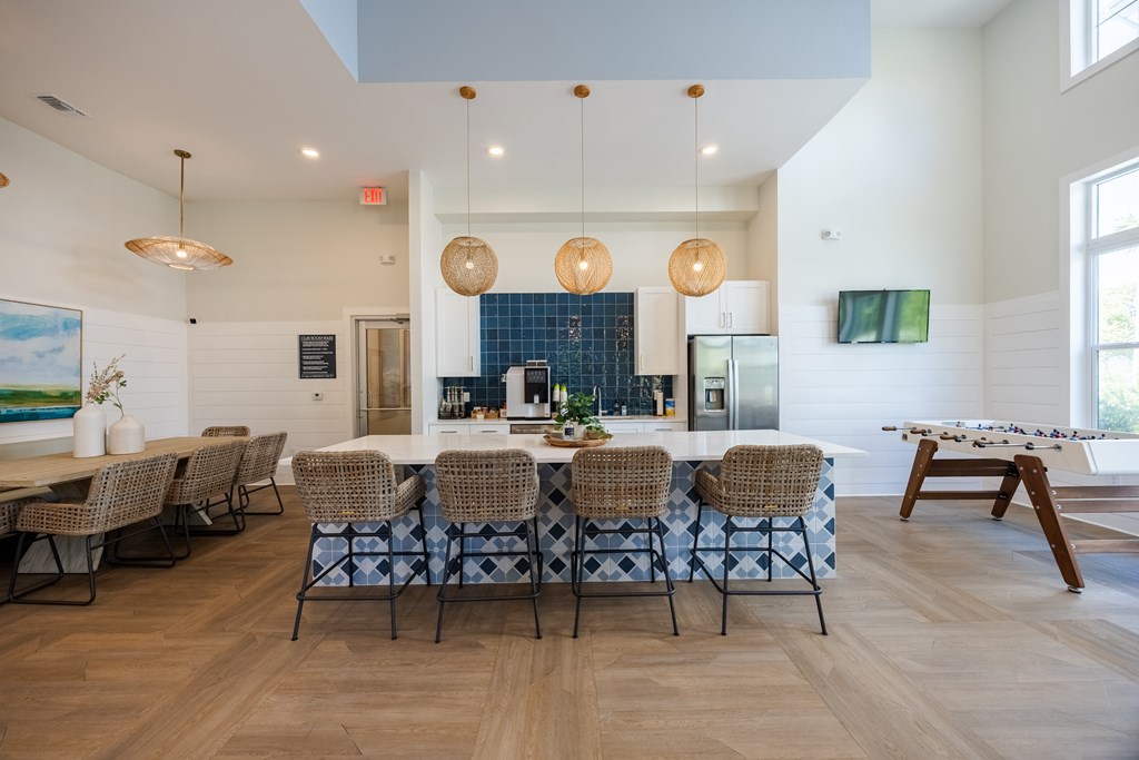 A dining room with a long table and chairs.