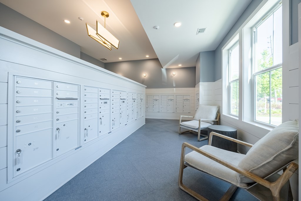 A room with a white wall and a chair.