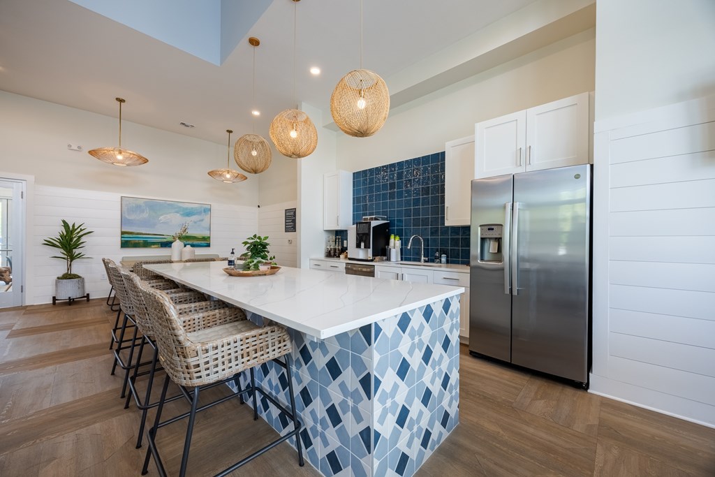 A kitchen with a blue and white tiled island.