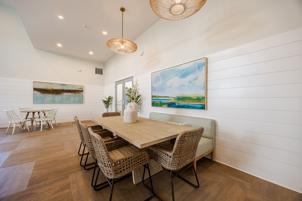 A dining room with a wooden table and chairs.