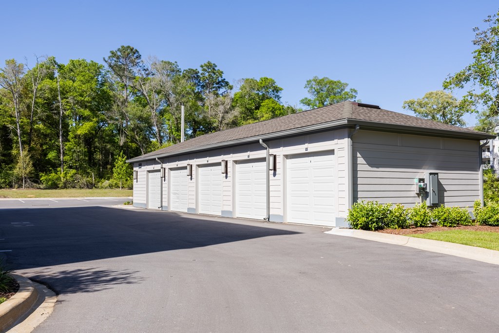 A grey building with a grey roof and grey garage doors.