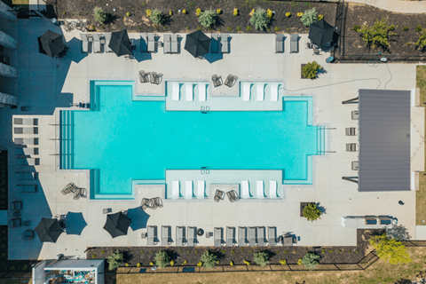 An aerial view of a swimming pool surrounded by lounge chairs.