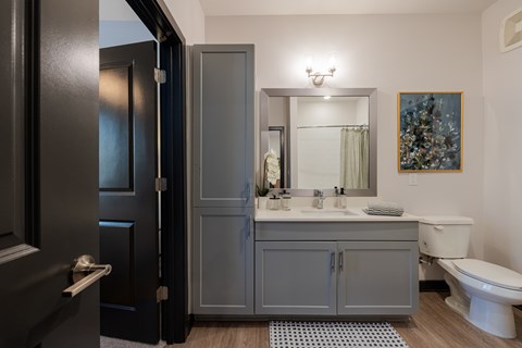 Spacious Bathroom with Storage, Upscale Lighting, Granite Countertops and Hardwood Floors