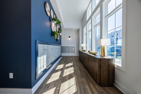 A long hallway with a blue wall and a white ceiling.