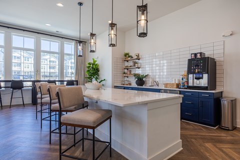 A kitchen with a white island and blue cabinets.