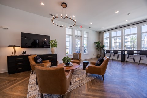 A living room with a brown chair and a wooden floor.