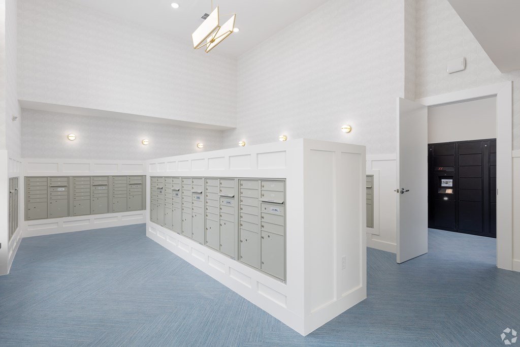 A room with a long row of lockers on the wall.