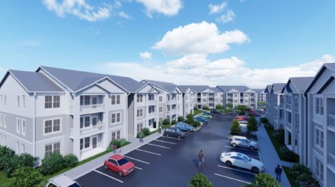 A row of white apartment buildings with cars parked in the driveways.