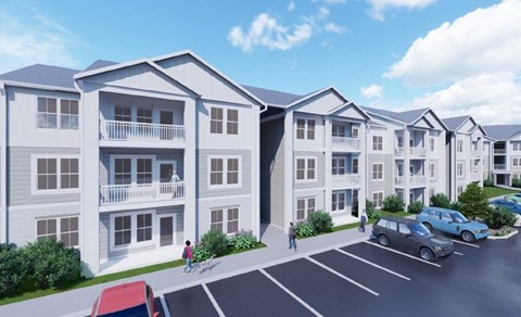 A row of apartment buildings with cars parked in front.