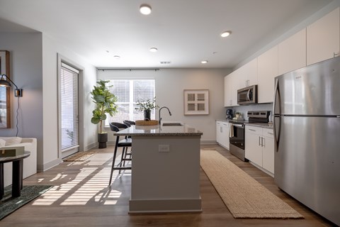 A modern kitchen with a dining table and chairs.