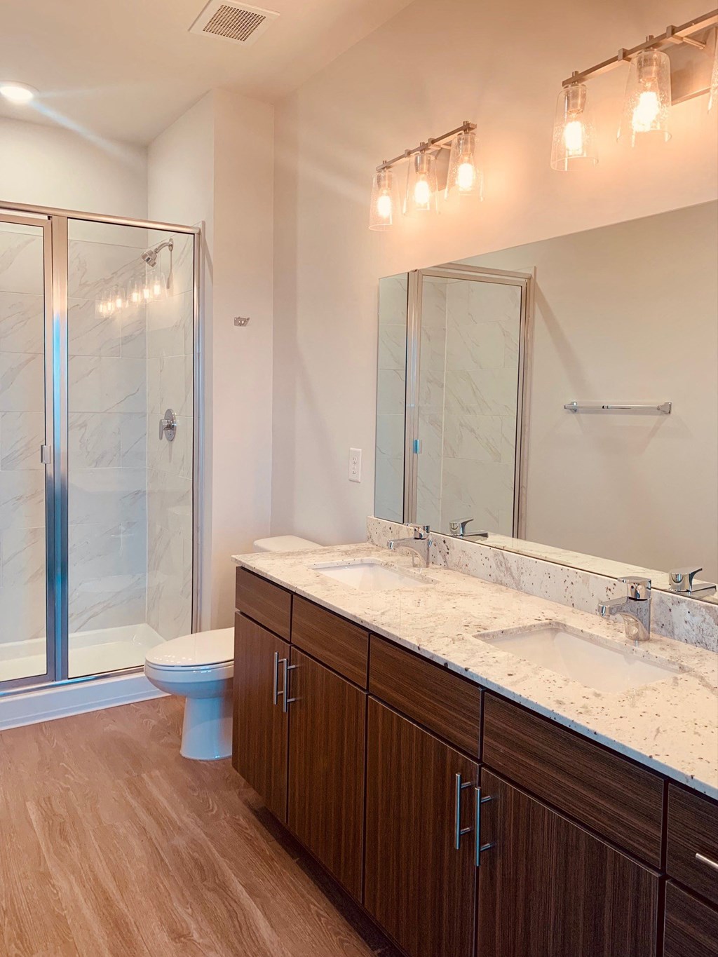 a bathroom with a toilet and a sink and a shower