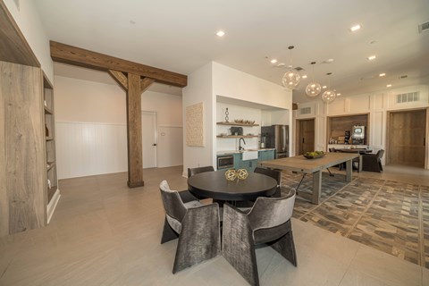 A modern dining room with a large table and chairs.