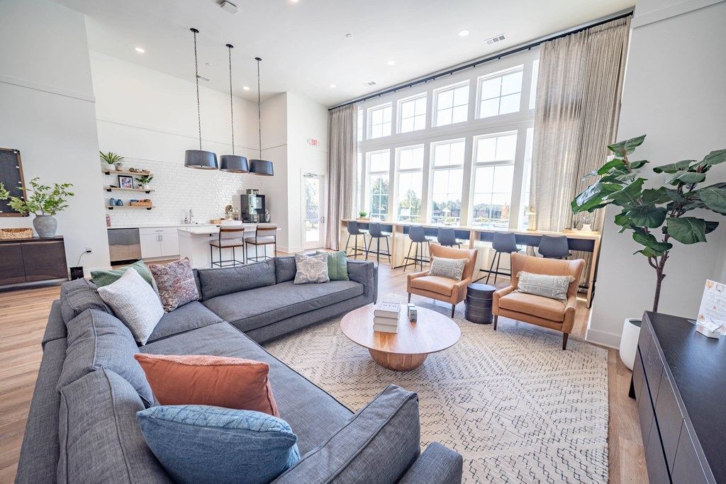 a living room with couches and chairs and a table