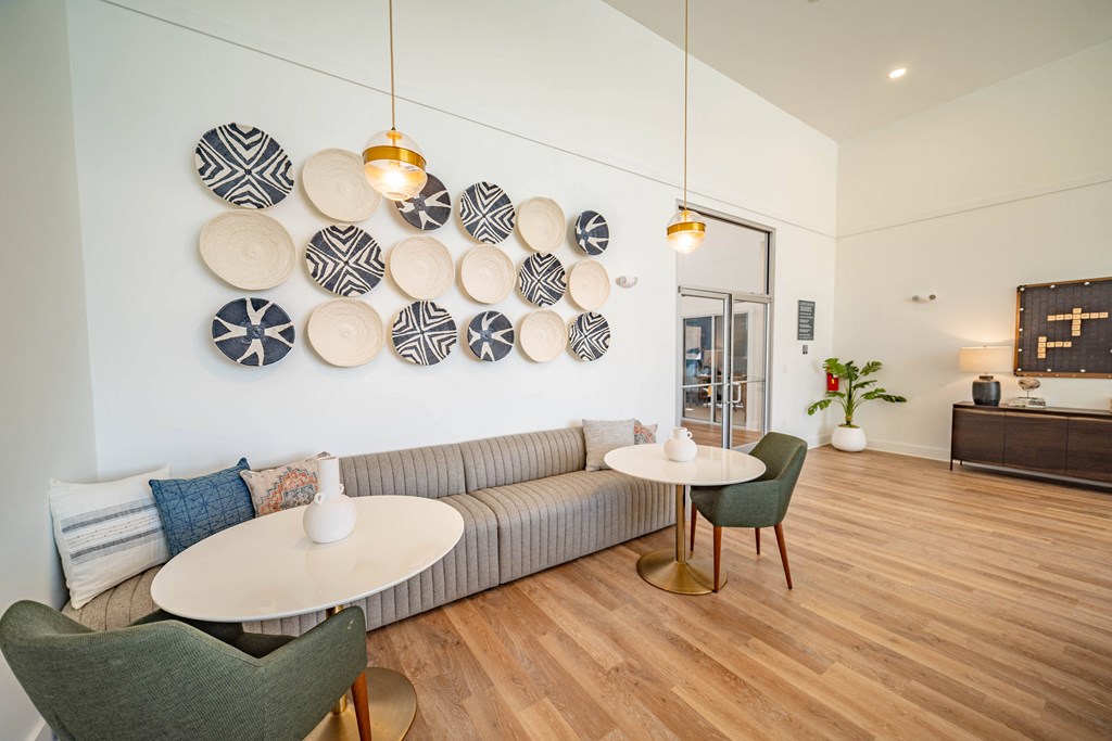 a living room with couches and tables and plates on the wall