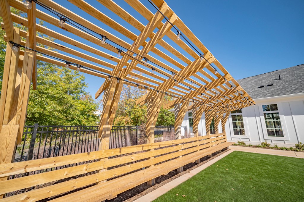 a wooden deck with a fence and a house