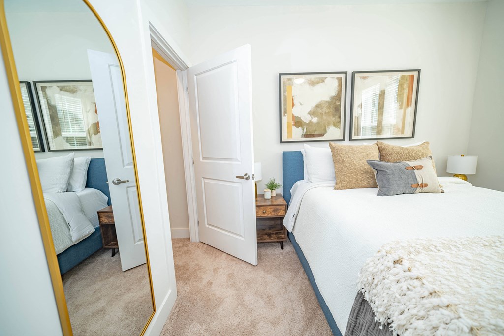 a bedroom with a bed and a mirror