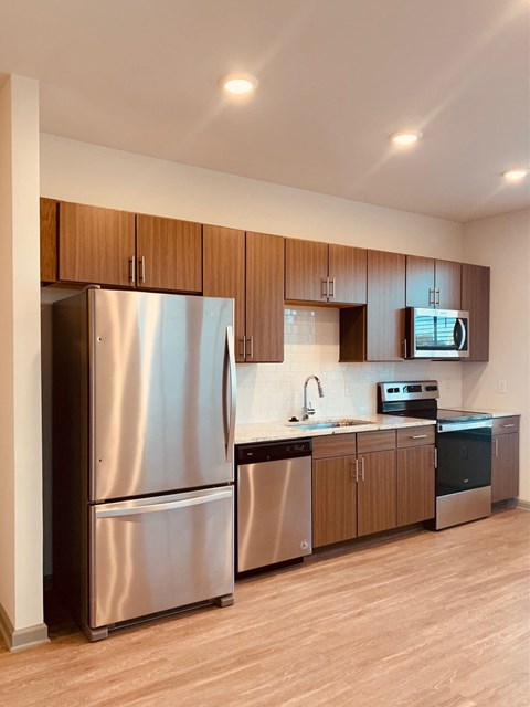 a kitchen with stainless steel appliances and wooden cabinets