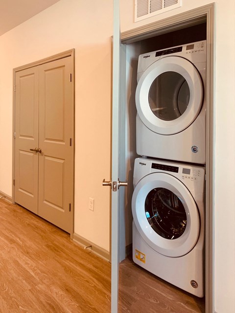 a front loading washer and dryer in a laundry room