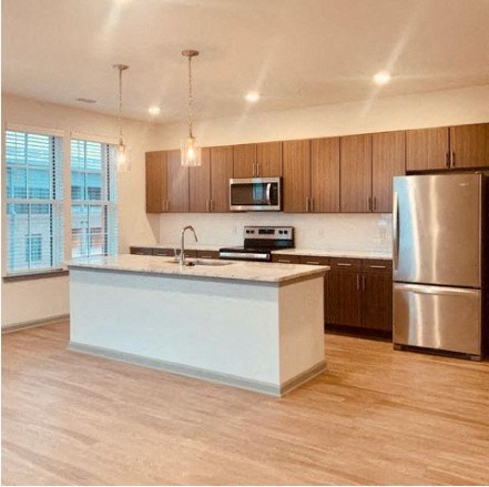 a kitchen with a stainless steel refrigerator and a sink