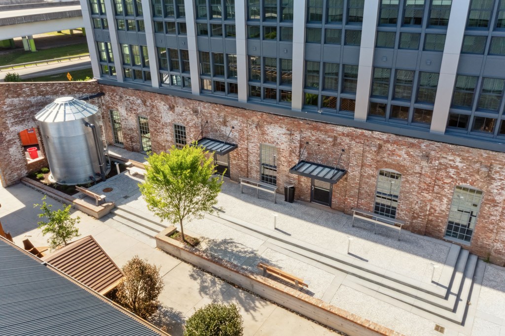 an aerial view of a brick building with a water tower