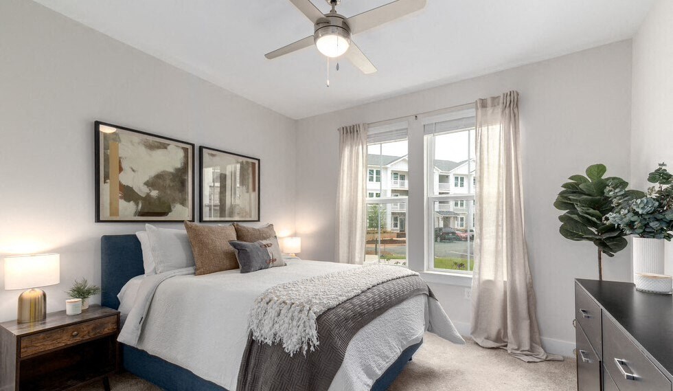 a bedroom with a ceiling fan and a window